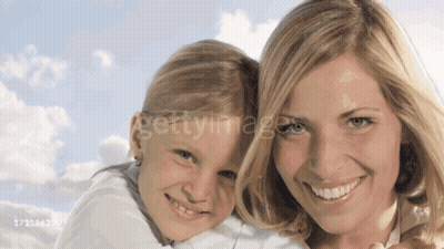 A Woman Is Holding A Little Girl In Her Arms And They Are Both Smiling For The Camera GIF