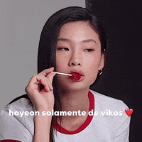 A Woman Is Holding A Lollipop In Her Mouth And The Caption Says Hoyeon Solamente De Viko GIF