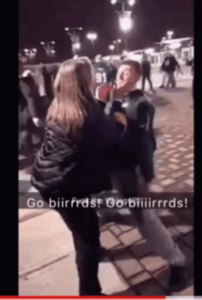 A Woman Is Holding A Man 'S Face In A Video That Says Go Biirfras GIF