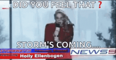 A Woman Is Holding A Microphone In Front Of A Newspaper Headline That Says Storm 'S Coming . GIF