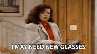 A Woman Is Holding A Pair Of Glasses And Says I May Need New Glasses GIF
