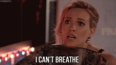 A Woman Is Holding A Piece Of Clothing And Saying I Can 'T Breathe GIF