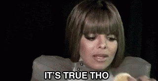 A Woman Is Holding A Piece Of Food In Her Hand And Eating It . GIF