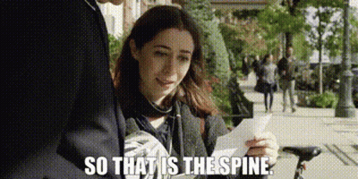 A Woman Is Holding A Piece Of Paper In Her Hand While Standing Next To A Man On A Sidewalk . GIF