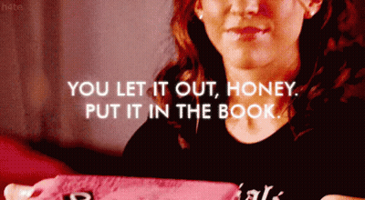 A Woman Is Holding A Pink Book With The Words " You Let It Out Honey Put It In The Book " GIF