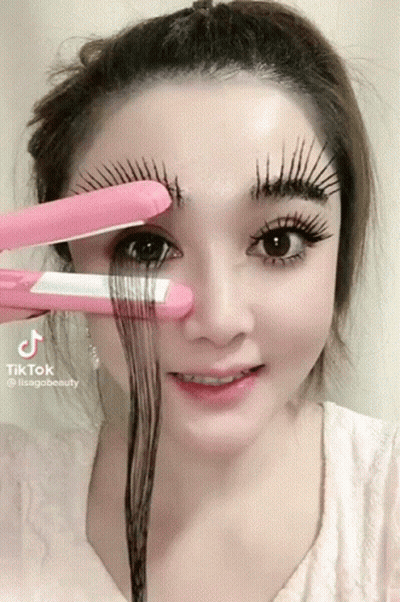 A Woman Is Holding A Pink Hair Straightener Over Her Eyebrows And The Hashtag Tiktok Is On The Bottom Right GIF