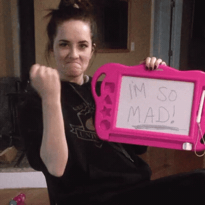 A Woman Is Holding A Pink Shaving Board That Says I 'M So Mad . GIF