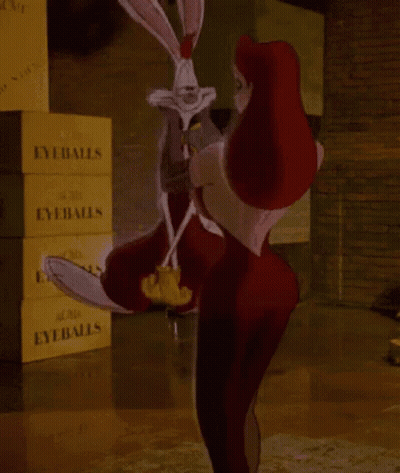 A Woman Is Holding A Rabbit In Front Of A Stack Of Eyeballs Boxes GIF