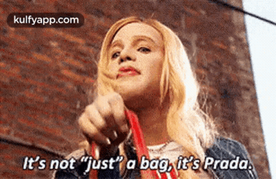A Woman Is Holding A Red Bag And Saying `` It 'S Not Just A Bag , It 'S Prada . GIF
