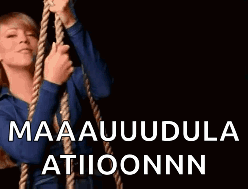 A Woman Is Holding A Rope With The Words Maaauudula Atiioonnn Written On It GIF