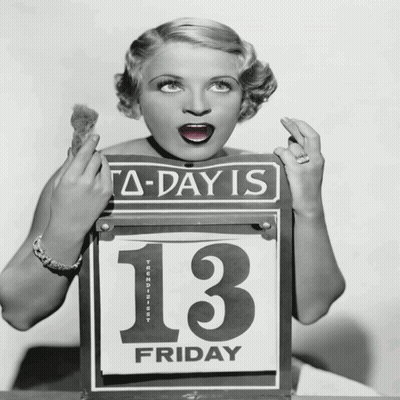 A Woman Is Holding A Sign That Says A-Day Is 13 Friday GIF