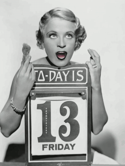 A Woman Is Holding A Sign That Says Today Is 13 Friday GIF