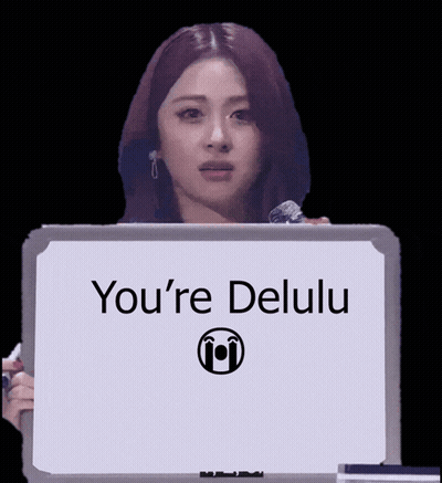 A Woman Is Holding A Sign That Says You 'Re Delulu GIF