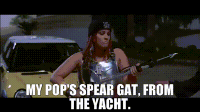 A Woman Is Holding A Spear In Front Of A Yellow Car . GIF
