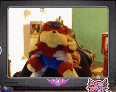 A Woman Is Holding A Stuffed Animal In Front Of A Tv Screen With A Sticker That Says J GIF