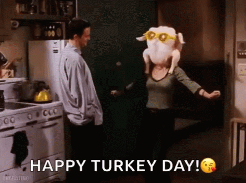 A Woman Is Holding A Stuffed Turkey On Her Head While A Man Stands Behind Her . GIF
