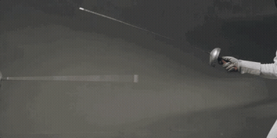A Woman Is Holding A Sword In Her Hand While Wearing A Mask . GIF