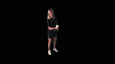 A Woman Is Holding A Tennis Racquet And A Tennis Ball . GIF