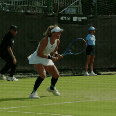 A Woman Is Holding A Tennis Racquet In Front Of A Challenger Tour Sign GIF