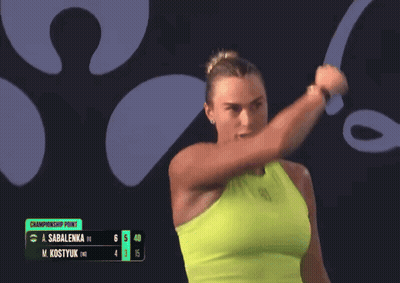 A Woman Is Holding A Tennis Racquet In Front Of A Championship Point GIF