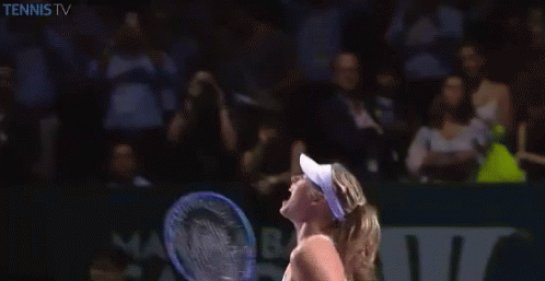 A Woman Is Holding A Tennis Racquet In Front Of A Tennis Tv Logo GIF