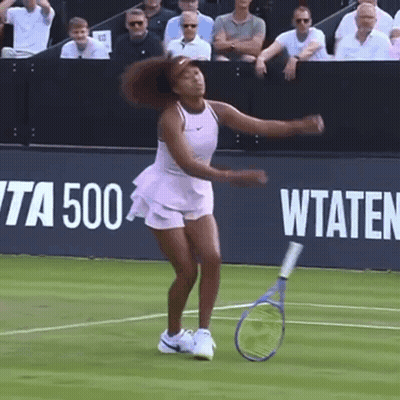 A Woman Is Holding A Tennis Racquet On A Tennis Court In Front Of A Banner That Says Wta 500 GIF