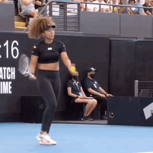 A Woman Is Holding A Tennis Racquet On A Tennis Court In Front Of A Sign That Says Match Time GIF