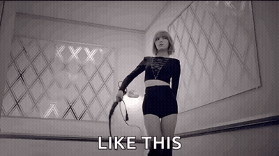 A Woman Is Holding A Whip In A Black And White Photo And The Words `` Like This '' Are Next To Her . GIF