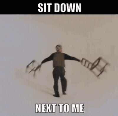 A Woman Is Holding Chairs In Her Hands With The Words Sit Down Next To Me GIF