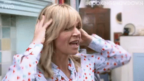 A Woman Is Holding Her Head With Her Hands And Screaming . GIF
