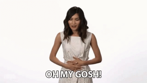 A Woman Is Holding Her Stomach And Says Oh My Gosh GIF