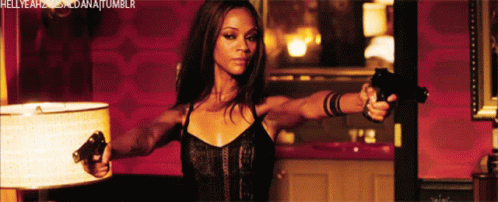 A Woman Is Holding Two Guns In Front Of A Lamp And The Words Hellyeah Dana Tumblr Are Visible GIF