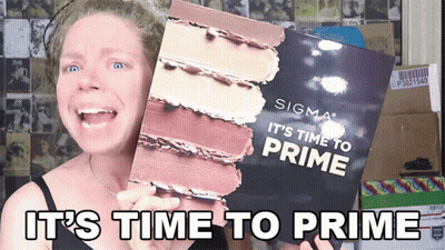 A Woman Is Holding Up A Sigma It 'S Time To Prime Book GIF