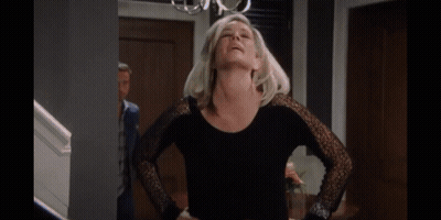 A Woman Is Hugging A Man With A Ring On Her Finger GIF