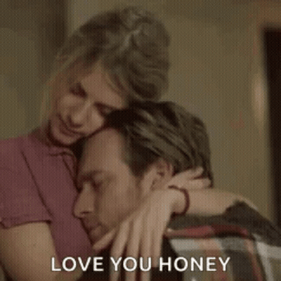 A Woman Is Hugging A Man With The Words `` Love You Honey '' Written On It . GIF