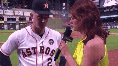 A Woman Is Interviewing A Baseball Player Who Is Wearing A Jersey That Says Astros GIF