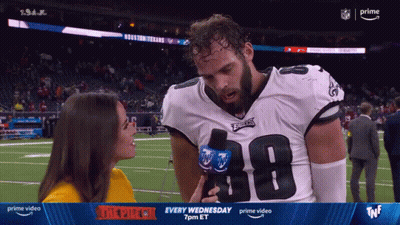 A Woman Is Interviewing A Football Player Wearing A Number 38 Jersey GIF