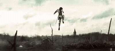 A Woman Is Jumping In The Air With A Sword And Shield In A Field . GIF