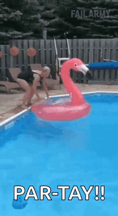 A Woman Is Jumping Into A Swimming Pool With A Flamingo Float . GIF