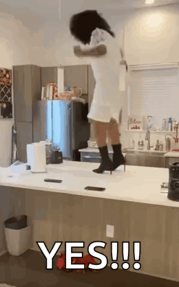 A Woman Is Jumping Over A Counter In A Kitchen While Wearing Heels . GIF