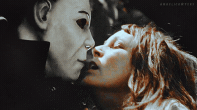 A Woman Is Kissing A Man In A Mask With Angelicanters Written On The Bottom Of The Image GIF