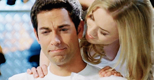 A Woman Is Kissing A Man On The Cheek While He Is Crying GIF