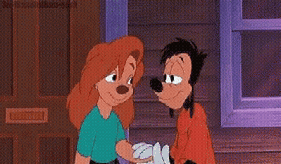 A Woman Is Kissing Goofy On The Cheek In A Cartoon . GIF