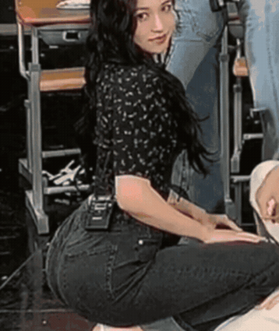 A Woman Is Kneeling Down In Front Of A Desk With A Name Tag That Says ' I ' On It GIF