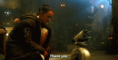 A Woman Is Kneeling Down In Front Of A Robot And Saying Thank You GIF