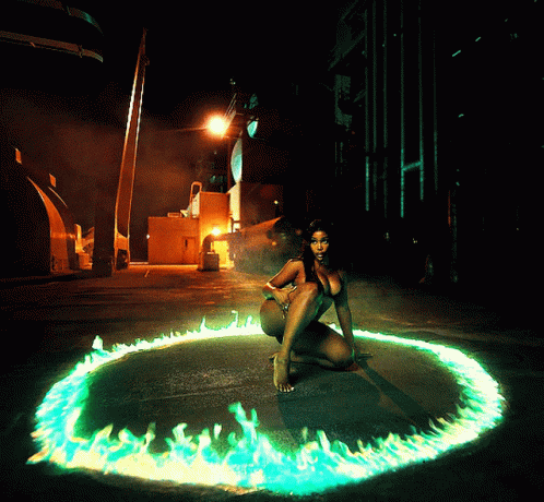 A Woman Is Kneeling In A Circle Of Green Flames GIF