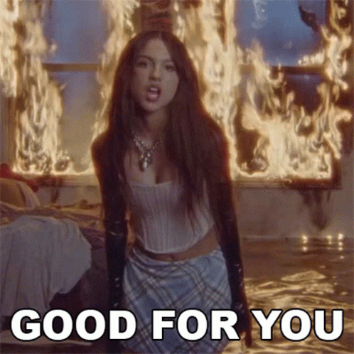 A Woman Is Kneeling In Front Of A Fire In A Room And Says `` Good For You '' . GIF