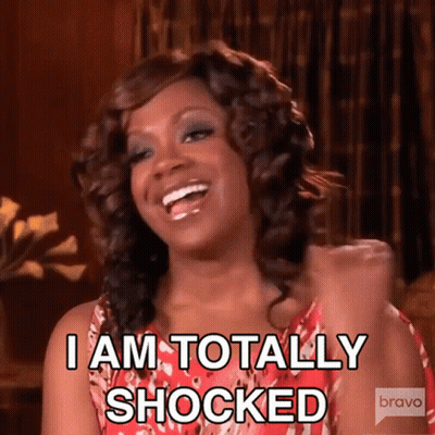 A Woman Is Laughing And Saying " I Am Totally Shocked " . GIF