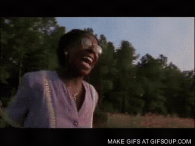 A Woman Is Laughing In A Field With Trees In The Background And The Words Make Gifs At Gifsoup.com GIF