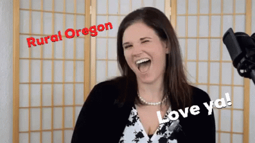 A Woman Is Laughing In Front Of A Microphone With Rural Oregon Written On The Top GIF